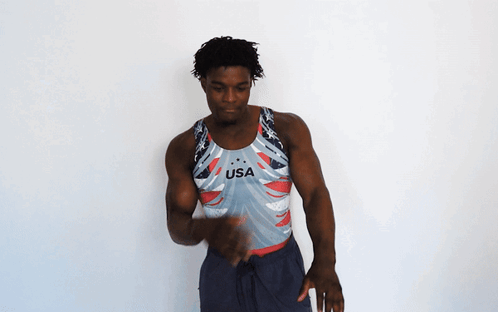 A Man Is Wearing A Usa Tank Top GIF