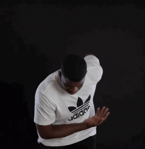 a man is wearing a white adidas shirt
