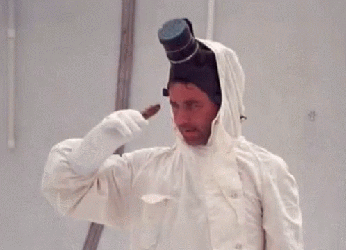 A Man Is Wearing A White Coat And Gloves And A Top Hat GIF