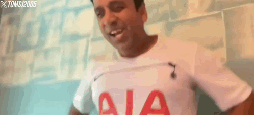 a man is wearing a white shirt with aia on it