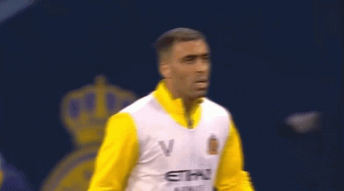 A Man Is Wearing A Yellow And White Etihad Airways Jersey GIF