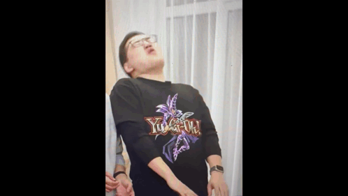 A Man Is Wearing A Yu Gi Oh Shirt GIF