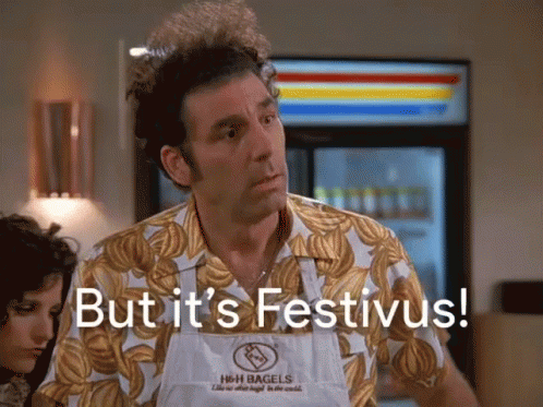 A Man Is Wearing An Apron That Says H & H Bagels GIF