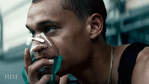 A Man Is Wearing An Oxygen Mask And The Word Him Is On The Bottom GIF