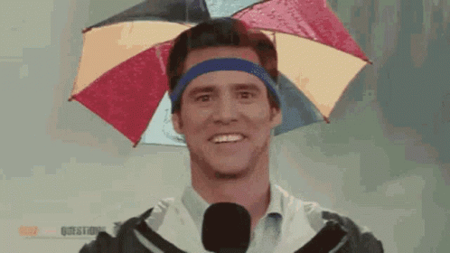 A Man Is Wearing An Umbrella On His Head GIF