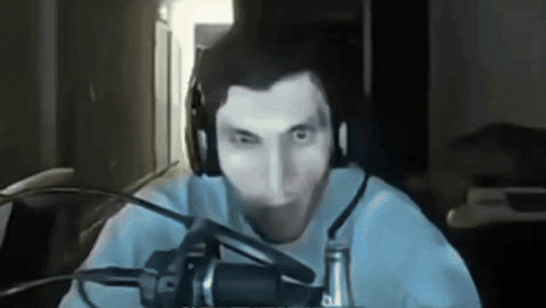 A Man Is Wearing Headphones And A Microphone GIF