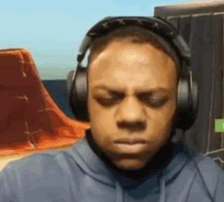 a man is wearing headphones and making a funny face .