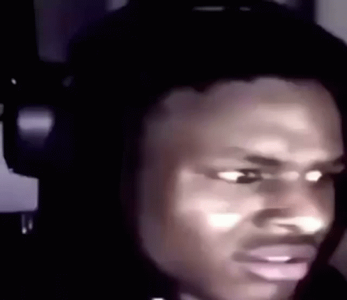 a man is wearing headphones and making a funny face .