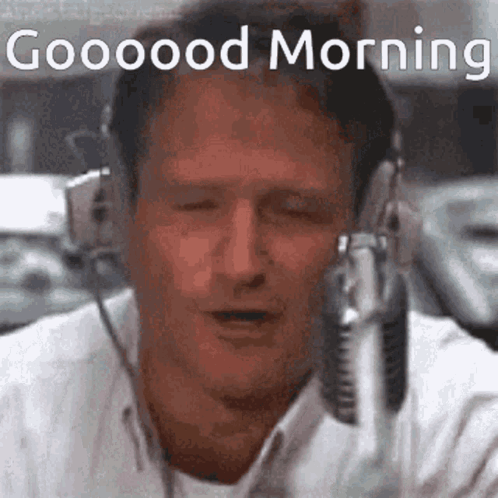 A Man Is Wearing Headphones And Singing Into A Microphone With The Words `` Good Morning '' Above Him . GIF