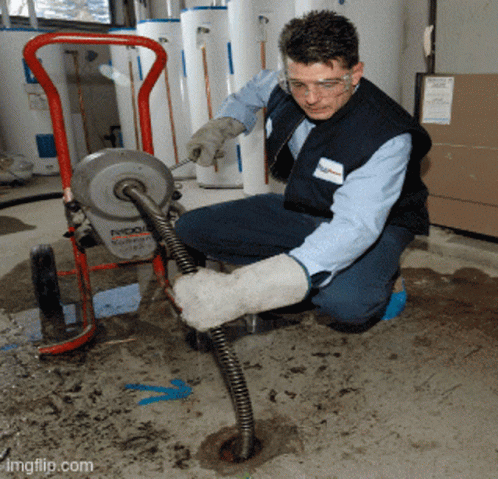 A Man Is Working On A Machine That Says Ridgid GIF