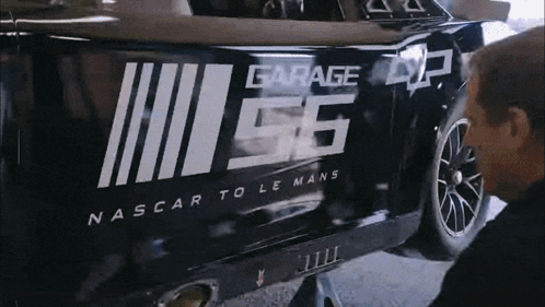 A Man Is Working On A Nascar Car With The Number 56 On It GIF