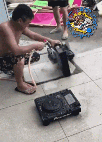 A Man Is Working On A Pioneer Dj Setup GIF