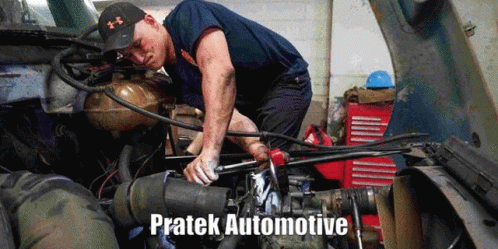 A Man Is Working On The Engine Of A Truck With The Words Pratek Automotive Written Below Him GIF