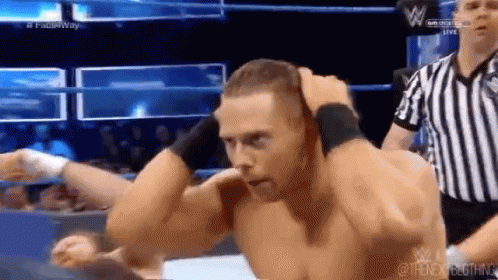A Man Is Wrestling Another Man In A Wrestling Ring . GIF
