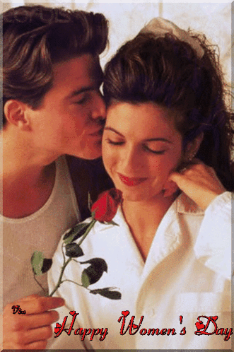 A Man Kissing A Woman On The Cheek With A Happy Women 'S Day Greeting GIF