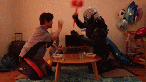 A Man Kneeling Next To A Monster With A Hammer GIF