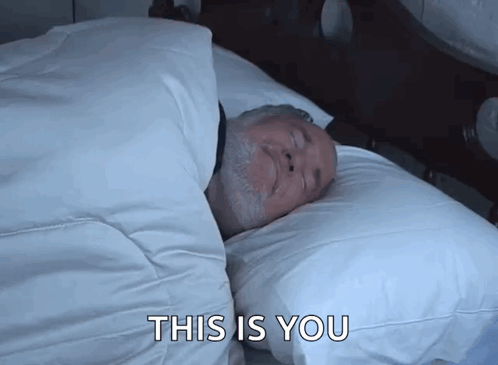 A Man Laying In A Bed With The Words This Is You Written Below Him GIF