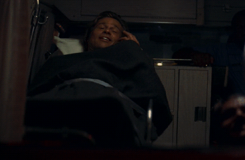 A Man Laying In A Chair With A Yellow I On It GIF