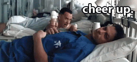 A Man Laying In A Hospital Bed With The Words Cheer Up Written Above Him GIF