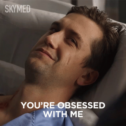 A Man Laying In A Hospital Bed With The Words " You 'Re Obsessed With Me " Above Him GIF