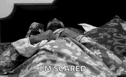 A Man Laying In Bed With The Words I 'M Scared Written Above Him GIF