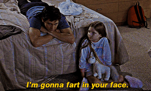 a man laying on a bed next to a little girl with the words i 'm gonna fart in your face on the bottom