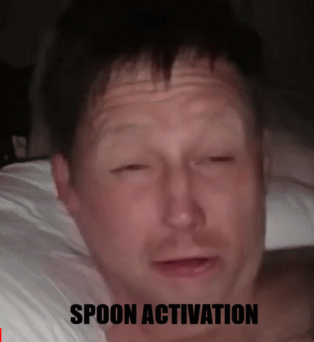 A Man Laying On A Bed With His Eyes Closed And The Words Spoon Activation Below Him GIF