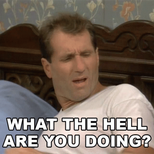 A Man Laying On A Bed With The Words What The Hell Are You Doing Behind Him GIF
