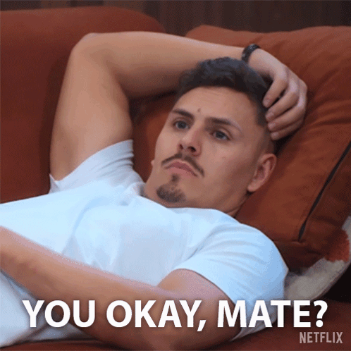 A Man Laying On A Couch With The Words " You Okay Mate " Written Below Him GIF
