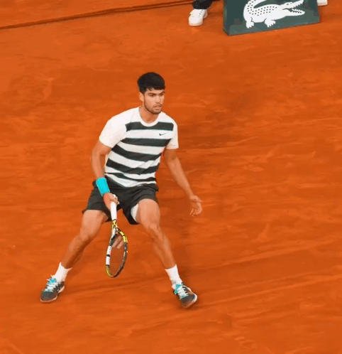 A Man Laying On A Tennis Court With A Babolat Tennis Racquet Next To Him GIF