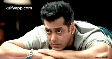 A Man Laying On His Stomach With His Head Resting On His Hands With The Website Kulfyapp.com In The Corner GIF