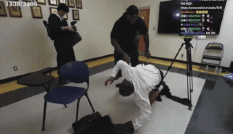 A Man Laying On The Floor In Front Of A Tv With The Number 3303/3400 On It GIF