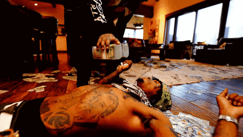 A Man Laying On The Floor With A Black Shirt That Says ' Dirty ' On It GIF