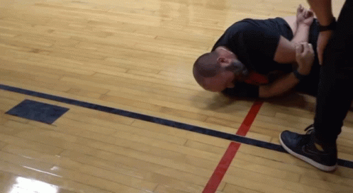 Man Lying On Floor With Red Line Between Him And Another Man GIF