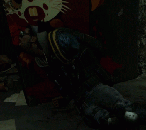 A Man Laying On The Ground In Front Of A Wall With A Picture Of A Cat And The Number 8 On It GIF