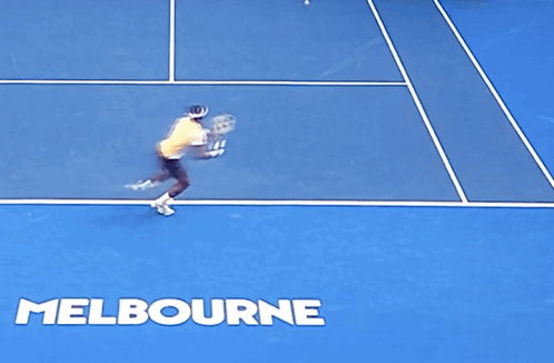 A Man Laying On The Ground On A Tennis Court With The Word Melbourne Written On It GIF