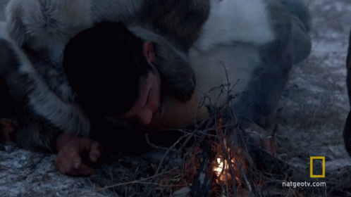A Man Laying On The Ground With A National Geographic Logo In The Background GIF