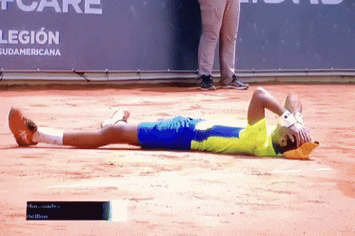 A Man Laying On The Ground With His Head In His Hands In Front Of A Banner That Says Legion GIF