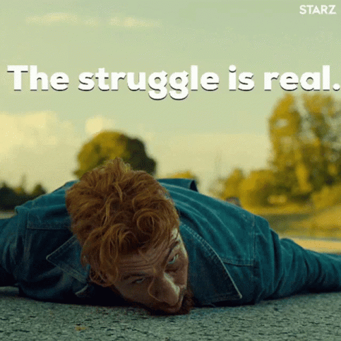 A Man Laying On The Ground With The Words " The Struggle Is Real " Written Above Him GIF