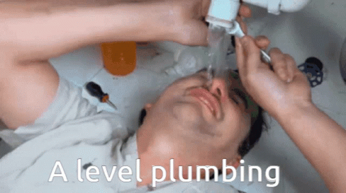 A Man Laying Under A Sink With The Words " A Level Plumbing " On The Bottom GIF