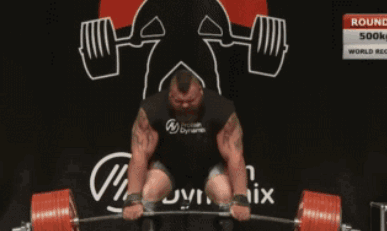 A Man Lifting A Barbell In Front Of A Sign That Says Round 3 GIF