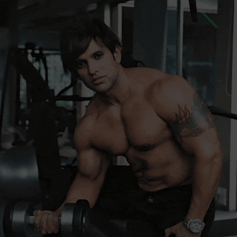 A Man Lifting A Dumbbell In A Gym With The Words Where Sweat Turns Into Strength GIF
