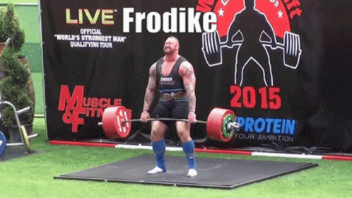 A Man Lifts A Barbell In Front Of A Sign That Says Live Frodike GIF