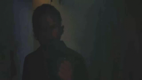 A Man Lighting A Cigarette With The Words " You Still " In The Background GIF