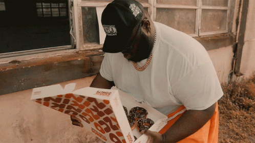 A Man Looking At A Dunkin Donuts Box GIF