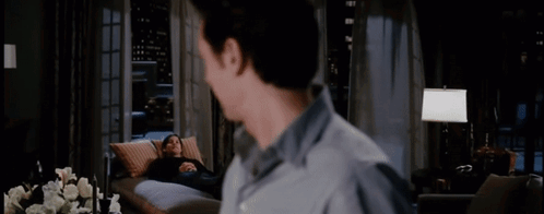 A Man Looking At A Woman Laying On A Couch With The Words " That Was Quite A Performance Today " GIF