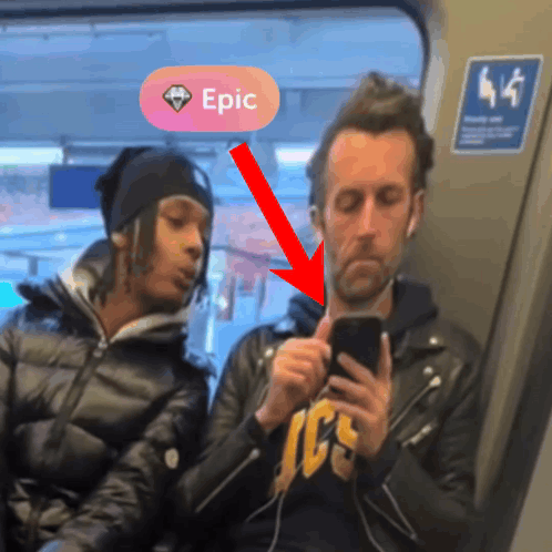 A Man Looking At His Phone Next To A Woman With A Pink Circle That Says Epic GIF