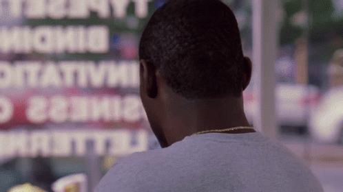 A Man Looking Out A Window At A Sign That Says ' Ottavia ' GIF