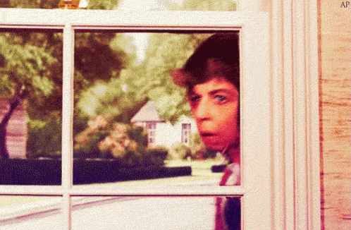 A Man Looking Out A Window With The Letters Ap Visible GIF