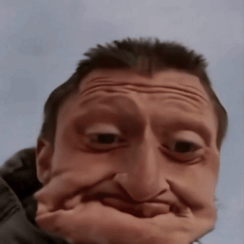A Man Making A Funny Face With His Hand GIF